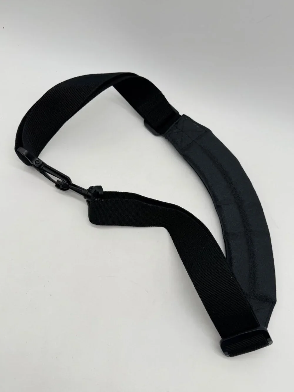 black Canon padded camera shoulder strap featuring an adjustable nylon web belt